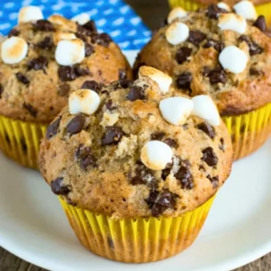 Delicious Banana S'mores Muffins topped with chocolate and graham crackers