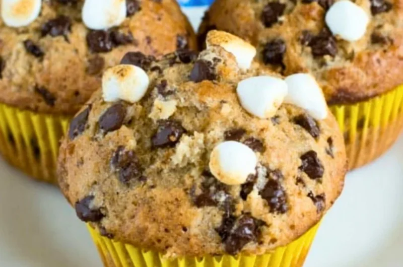 Delicious Banana S'mores Muffins topped with chocolate and graham crackers
