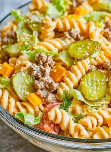 Delicious Big Mac Pasta Salad served in a bowl, featuring pasta and burger ingredients.