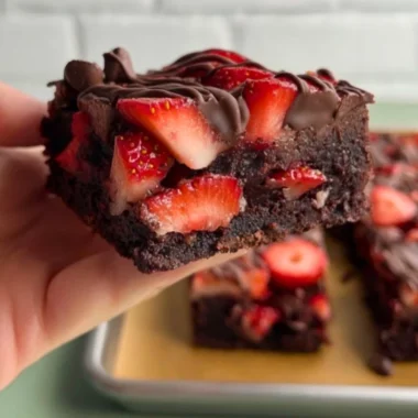 Delicious chocolate covered strawberry brownies topped with fresh strawberries