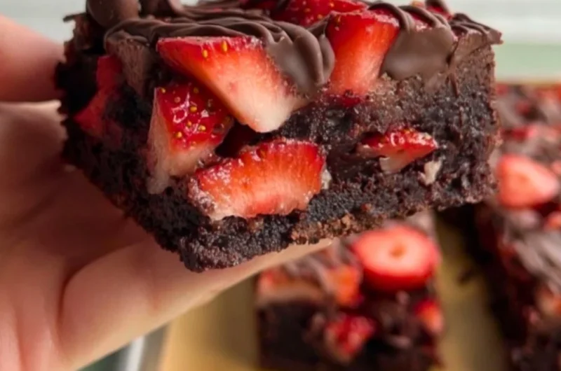 Delicious chocolate covered strawberry brownies topped with fresh strawberries