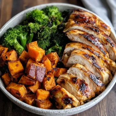 Grilled chicken and sweet potato bowl garnished with fresh herbs