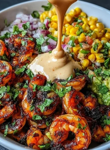 Grilled shrimp bowl with avocado, corn salsa, and creamy garlic sauce.