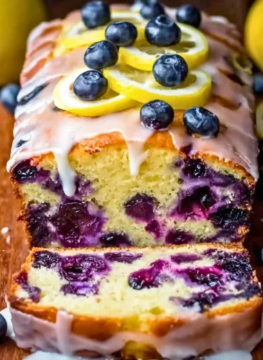 A bowl of homemade blueberry yogurt topped with fresh blueberries.
