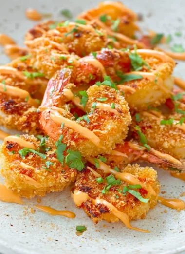 Keto Bang Bang Shrimp served on a plate with sauce and garnishes