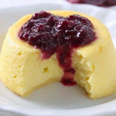 Delicious Keto Microwave Cheesecake topped with fresh berries and whipped cream