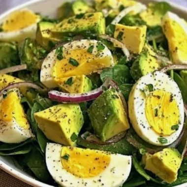 Power salad with avocado, egg, and spinach in a vibrant bowl