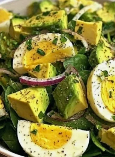 Power salad with avocado, egg, and spinach in a vibrant bowl