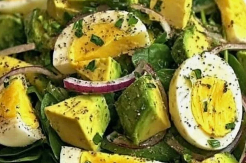 Power salad with avocado, egg, and spinach in a vibrant bowl