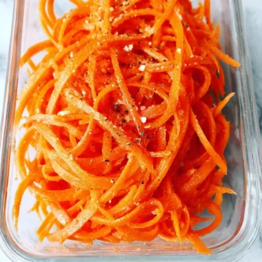 Fresh raw carrot salad with vibrant colors and healthy ingredients