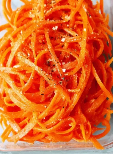 Fresh raw carrot salad with vibrant colors and healthy ingredients