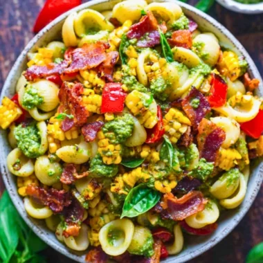 Summer pasta salad with corn, bell pepper, bacon, and creamy pesto dressing