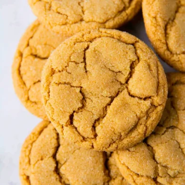 A plate of freshly baked chewy brown sugar cookies with a golden brown hue.