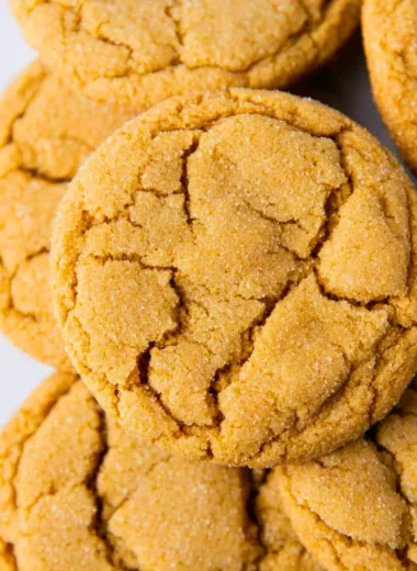 A plate of freshly baked chewy brown sugar cookies with a golden brown hue.