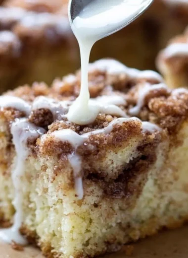 Delicious homemade coffee cake with a crumbly topping and coffee cup