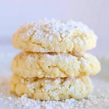 Delicious cream cheese cookies on a plate, showcasing their soft texture and creamy topping.