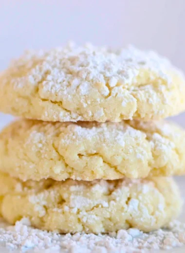 Delicious cream cheese cookies on a plate, showcasing their soft texture and creamy topping.