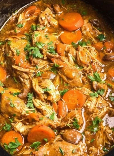 Crockpot chicken thigh pot roast with vegetables in a rustic dish