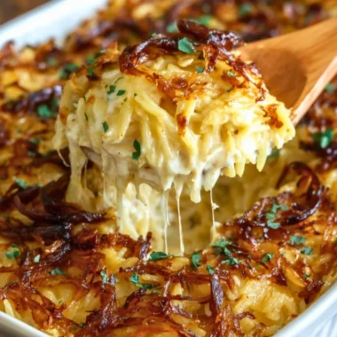 French Onion Chicken Orzo Casserole dish, garnished with cheese and herbs.