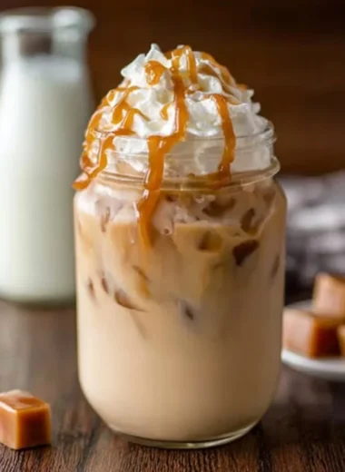 Delicious iced caramel latte topped with caramel drizzle and whipped cream