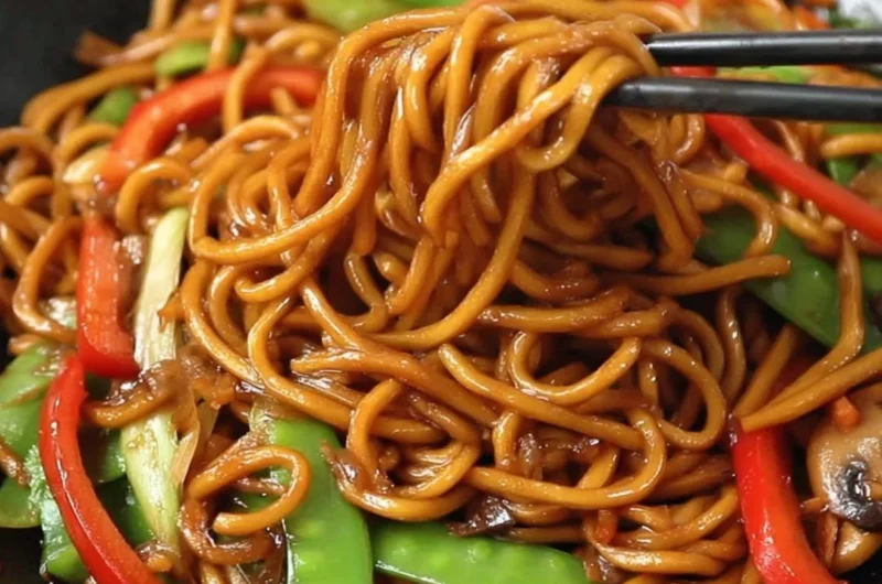 Delicious bowl of Lo Mein noodles with colorful vegetables and proteins
