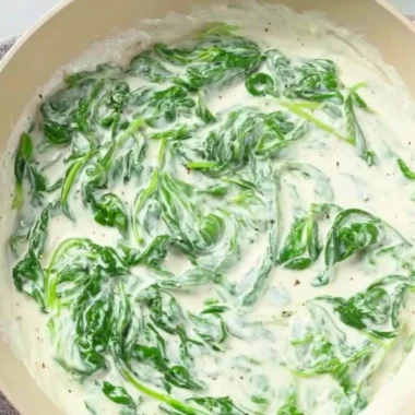 Pasta with Spinach Sauce served in a bowl garnished with fresh herbs