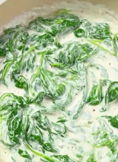 Pasta with Spinach Sauce served in a bowl garnished with fresh herbs