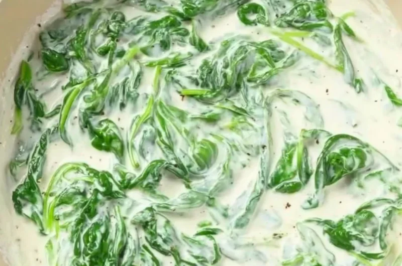 Pasta with Spinach Sauce served in a bowl garnished with fresh herbs