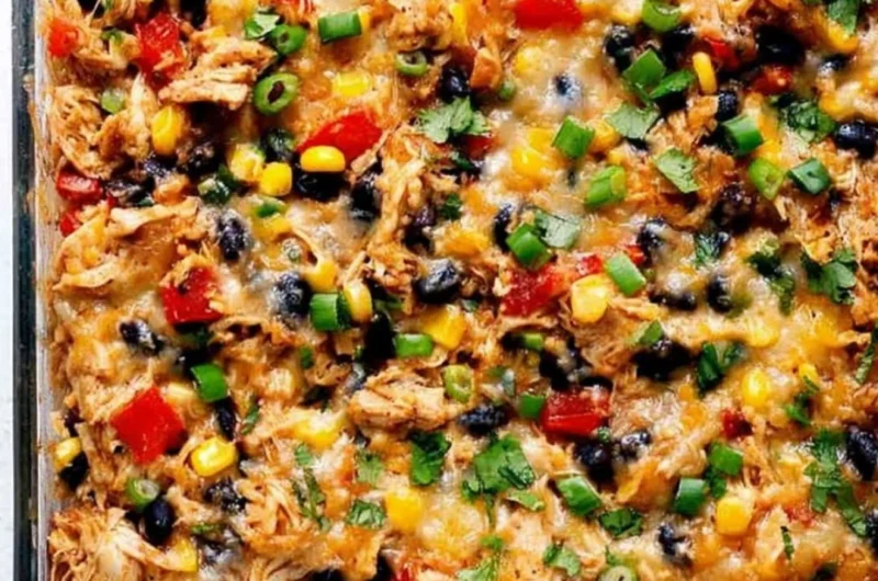 Protein Burrito Casserole topped with cheese and garnished with fresh herbs.