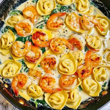 Shrimp tortellini with garlic sauce in a serving dish, garnished with parsley