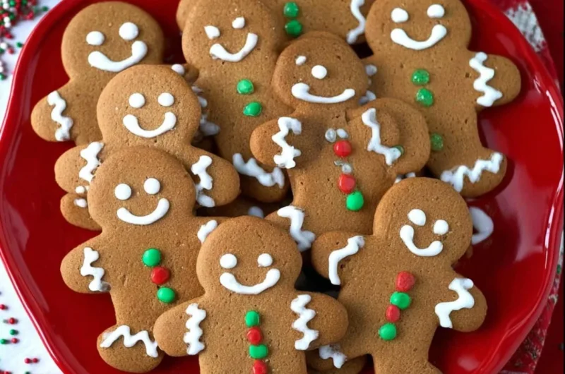 Freshly baked soft and chewy gingerbread men cookies on a cooling rack