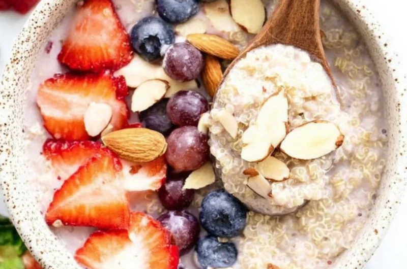 Strawberry quinoa breakfast bowl topped with fresh berries and nuts