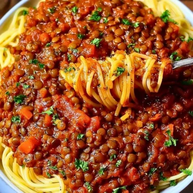Bowl of Vegan Bolognese with pasta and fresh herbs