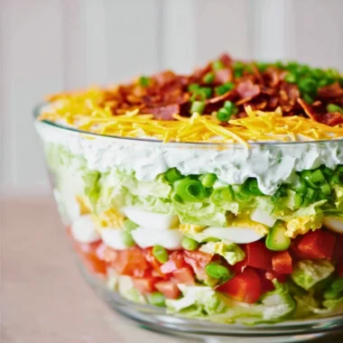 Delicious 7 Layer Salad featuring fresh vegetables and creamy layers