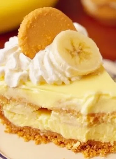 Delicious banana pudding cheesecake topped with vanilla wafers and banana slices