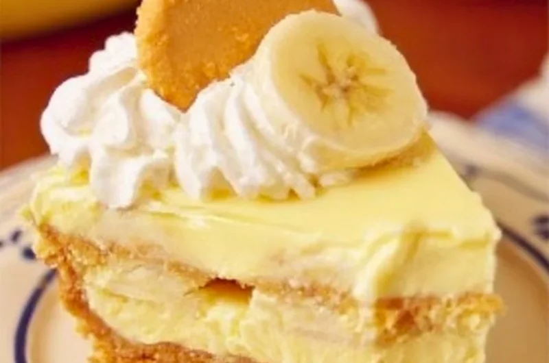 Delicious banana pudding cheesecake topped with vanilla wafers and banana slices