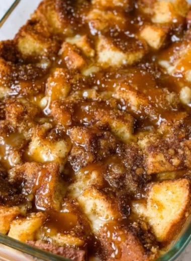 Delicious homemade bread pudding topped with creamy sauce and spices
