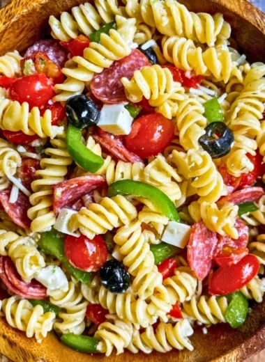 Bowl of Easy Italian Pasta Salad with fresh vegetables and dressing