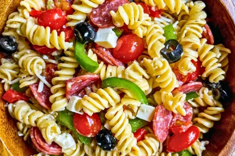 Bowl of Easy Italian Pasta Salad with fresh vegetables and dressing