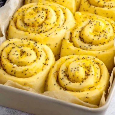 Delicious lemon rolls topped with icing, showcasing a bright yellow filling