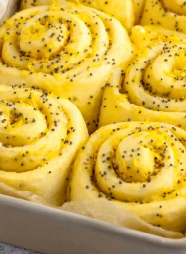 Delicious lemon rolls topped with icing, showcasing a bright yellow filling
