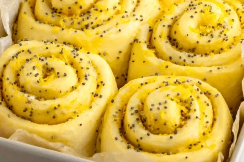 Delicious lemon rolls topped with icing, showcasing a bright yellow filling