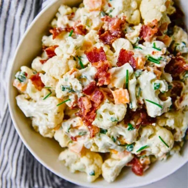 Loaded cauliflower salad with fresh vegetables and dressing