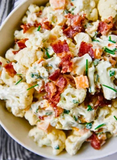 Loaded cauliflower salad with fresh vegetables and dressing