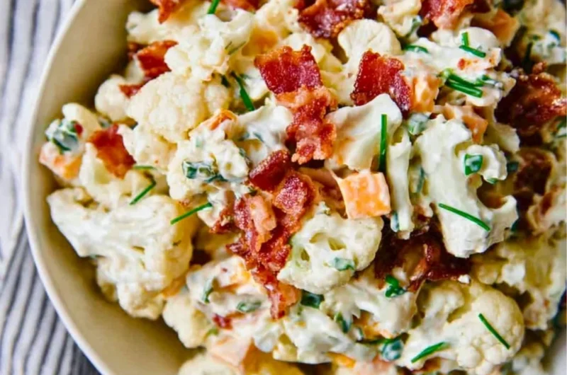 Loaded cauliflower salad with fresh vegetables and dressing