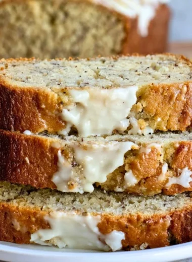 Loaf of Perfect Banana Bread fresh out of the oven on a wooden table