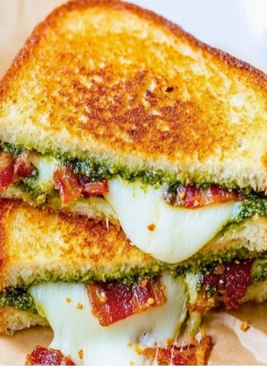 Mouthwatering Pesto Grilled Cheese sandwich with melted cheese and fresh basil pesto