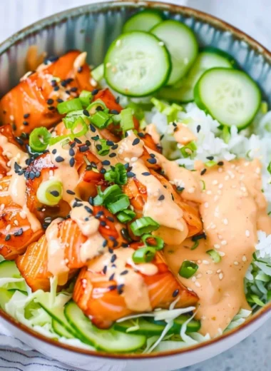 Delicious spicy salmon bowl garnished with fresh vegetables and sauce