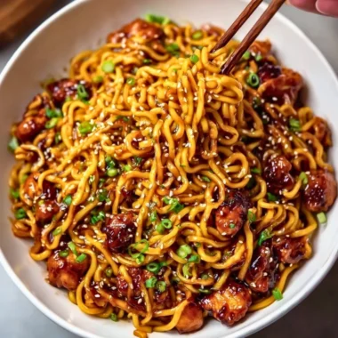 Delicious sticky garlic chicken noodles served in a bowl