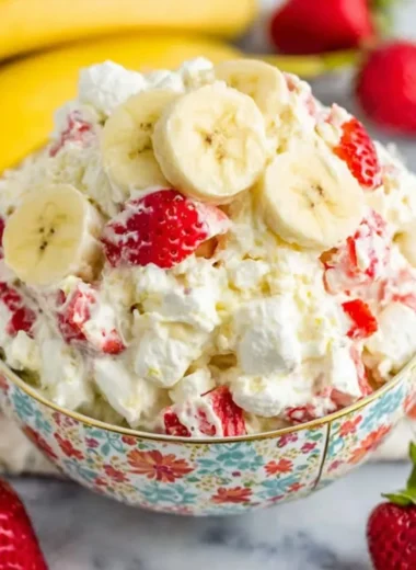Delicious Strawberry Banana Fluff Salad served in a bowl with fresh strawberries and bananas